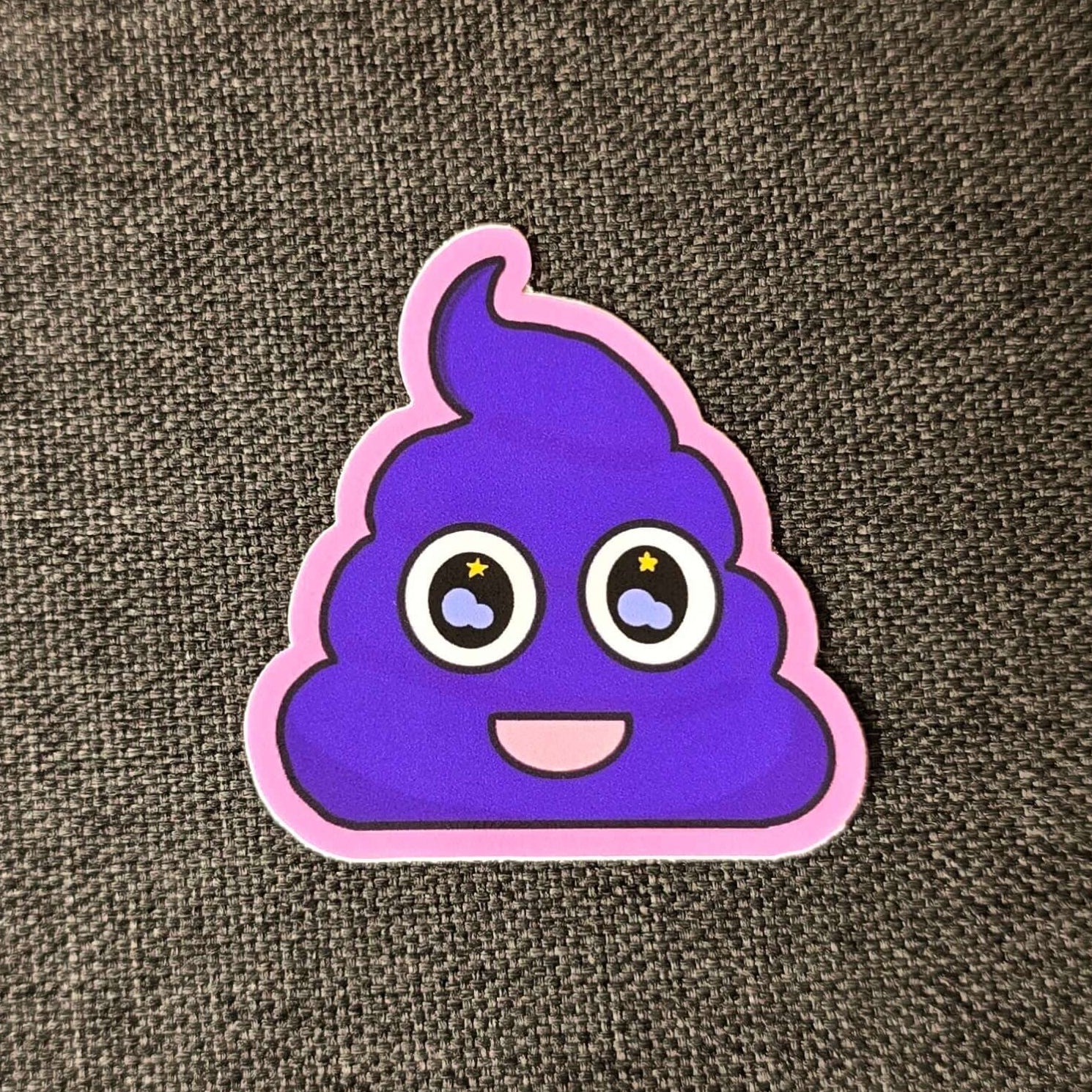 Image of a purple ube ice cream smiling with stars in its eyes. The sticker has a pink outline.